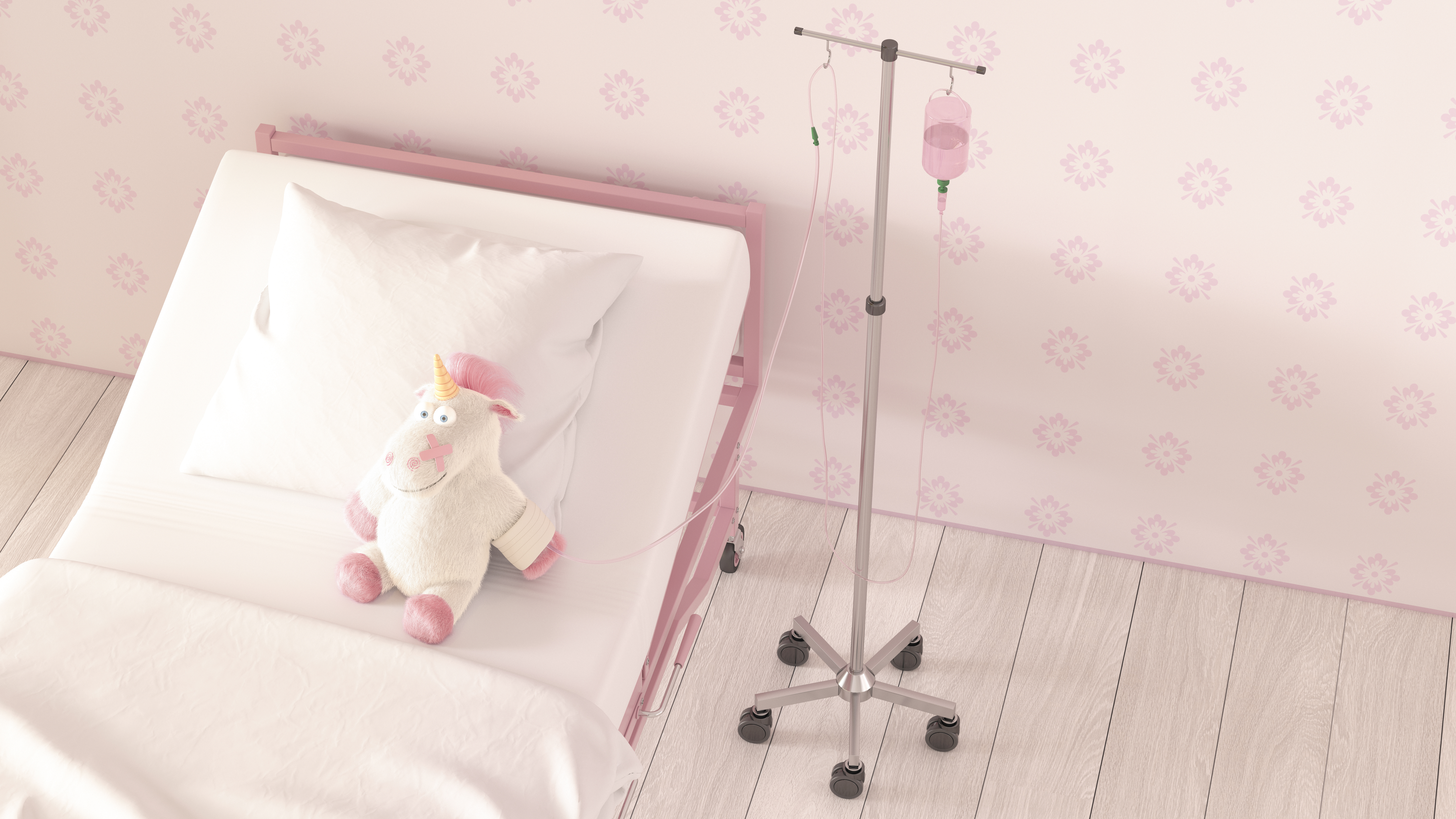 Image of a stuffed unicorn sitting in a hospital bed hooked up to an IV