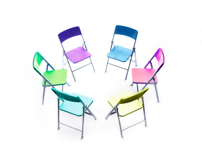 Circle of chairs of different colours.